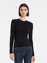 a lady wearing a black detachable sleeve woolen round neck sweater